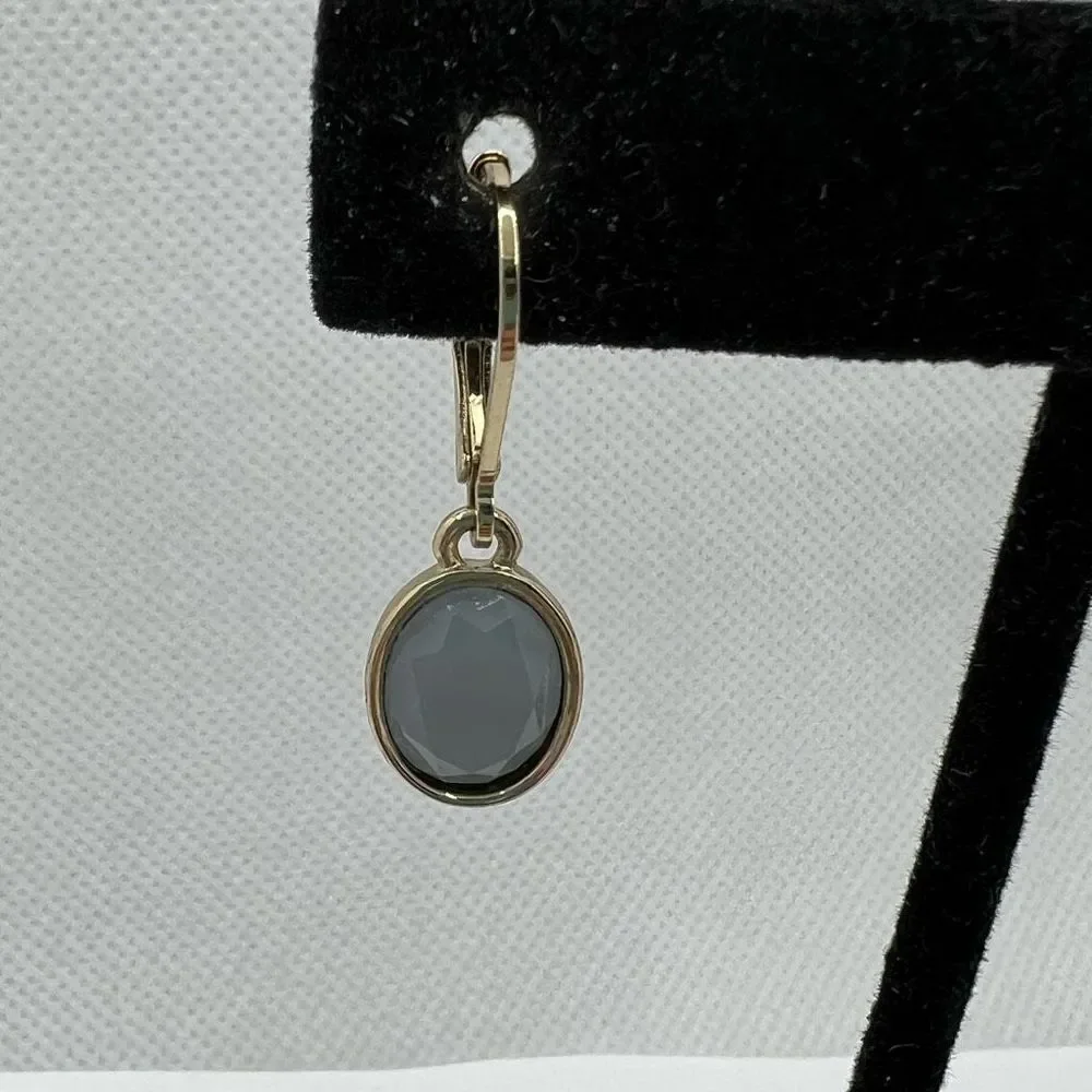 Faceted blue grey hinge dangle earrings on gold tone backing